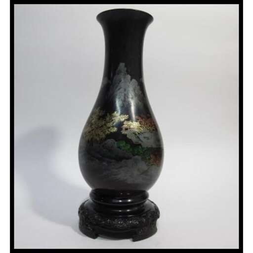 a black vase with a black vase on a white background