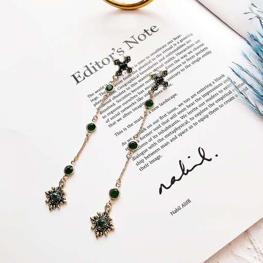 a set of green and black floral beads and a touch of green.