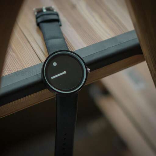 a watch with a sad face on it.