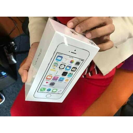 a person holding up a box with a cell phone inside.