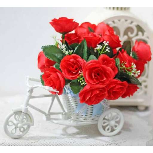 a basket of roses with a bicycle and a cart