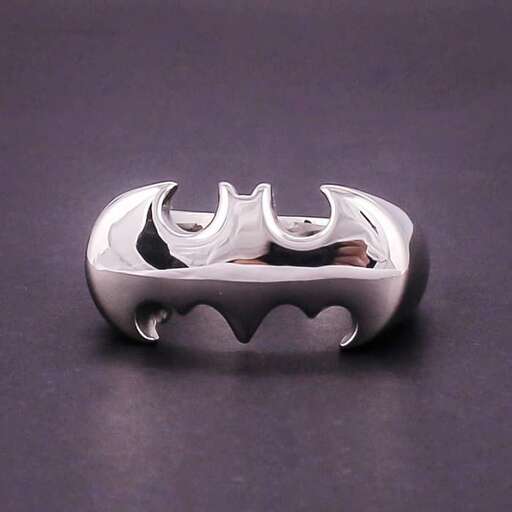 a silver ring with a black and white dragonfly in the middle.