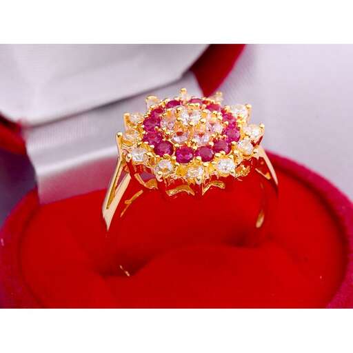 a ring with a pink sapphire and diamond