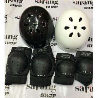 a black and white egg with holes and a white helmet.