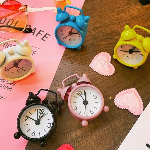 a table with a clock, a clock, and hearts.