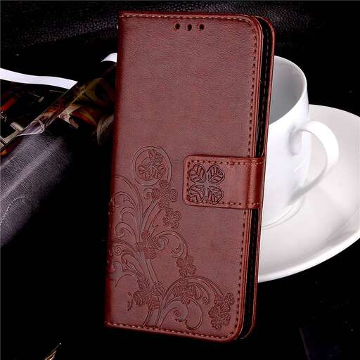 a red leather wallet sitting on top of a white plate.