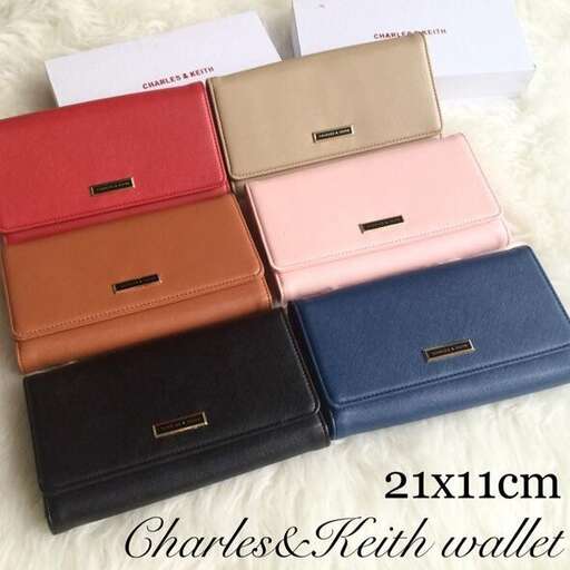 a wallet that is sitting on a white blanket.