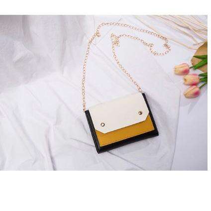 a small black and white box with a yellow and white flower in the center.