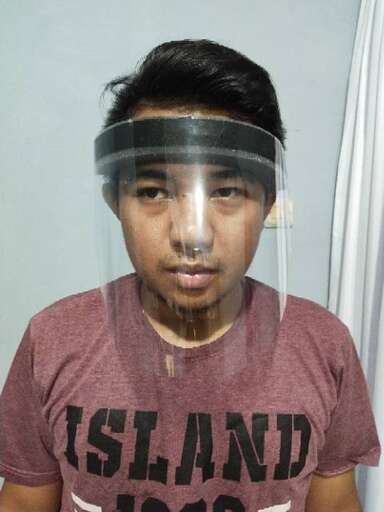 a boy with a plastic mask on his face