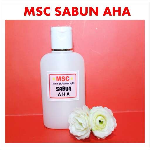 a bottle of perfume with a flower in it