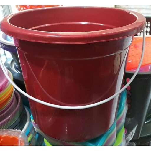 a red plastic flower pot with a handle.