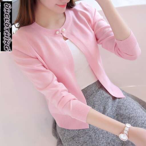 pink blouse with a pearl necklace