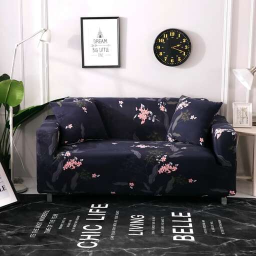 a couch sitting in a living room next to a clock.