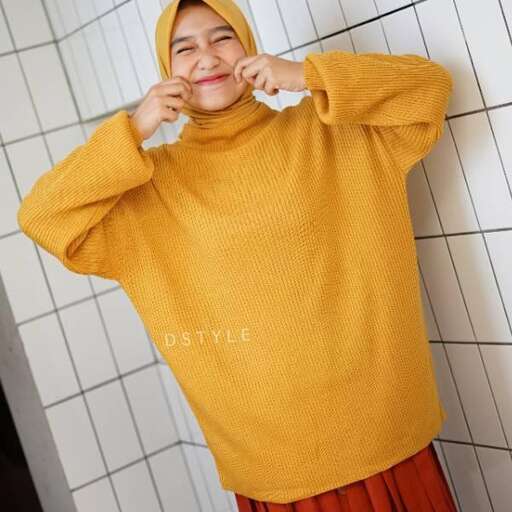 a girl in a yellow sweater