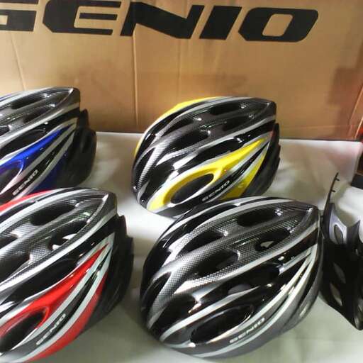 a number of helmets on a table with a box