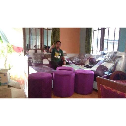 a woman sitting on a bed in a room.