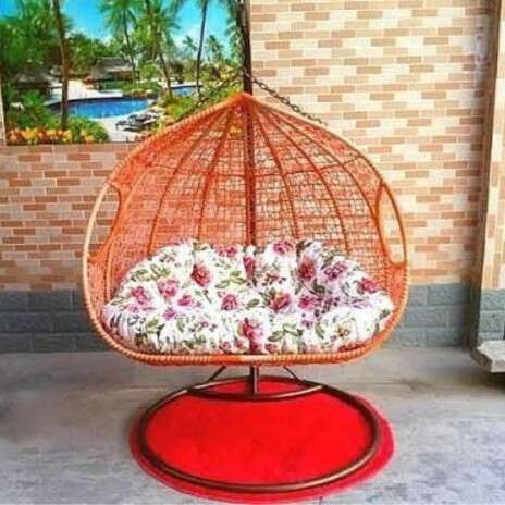 a bird cage with flowers inside of it.
