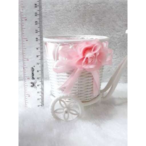 a tea cup with a pink ribbon and a bow