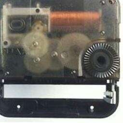 a small black and white camera with a red cord.