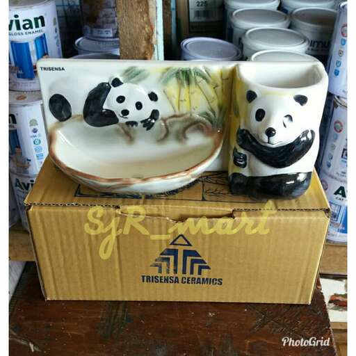 two pandas sitting on a box in a store.
