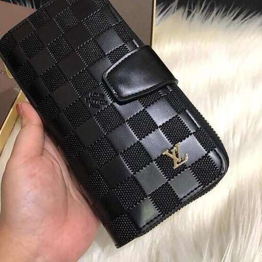 a wallet that is black and white with a gold design.