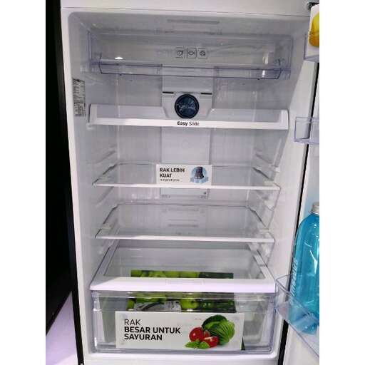 a refrigerator with a small freezer inside of it.