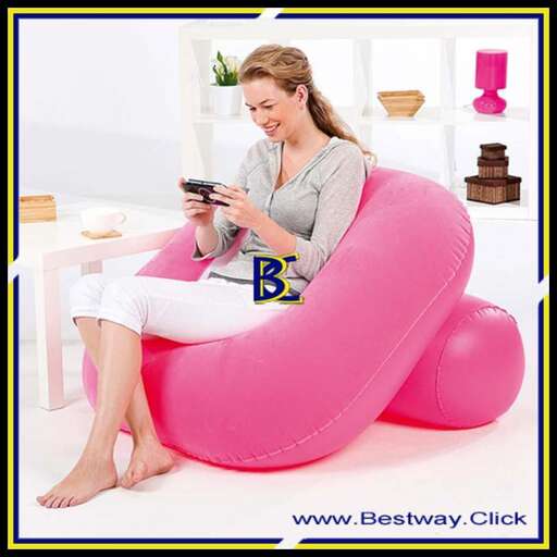 a girl sitting in a pink chair