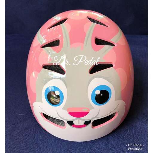 this helmet is made of plastic and has a pink face.