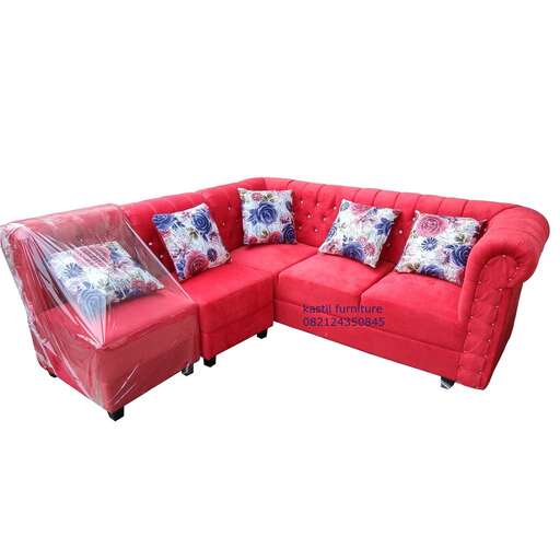 a red couch with a cushioned seat.