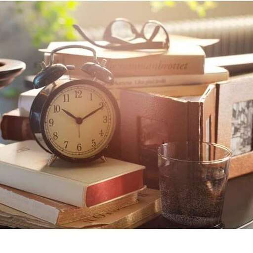 a clock sitting on top of a bookshelf.