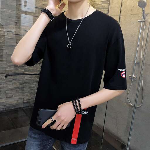 person is wearing a black shirt with a red strap