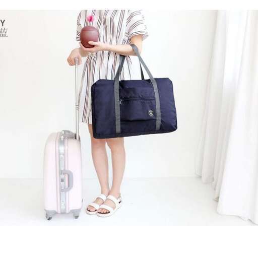 a woman holding a bag and a suitcase.