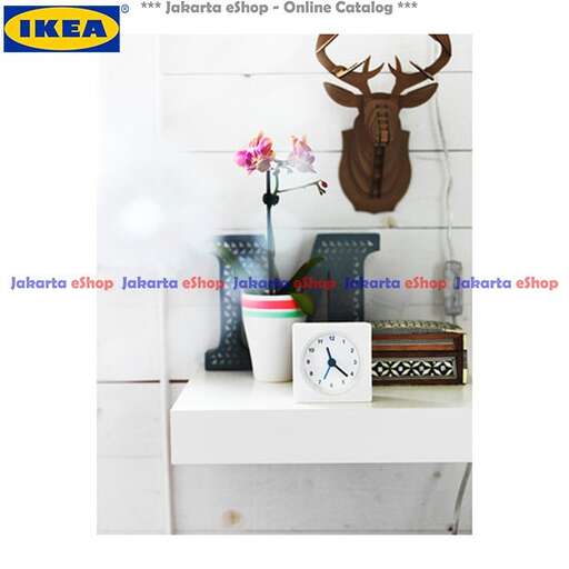 a clock and a vase of flowers on a shelf