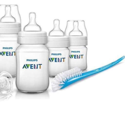 a baby bottle with a toothbrush in it.