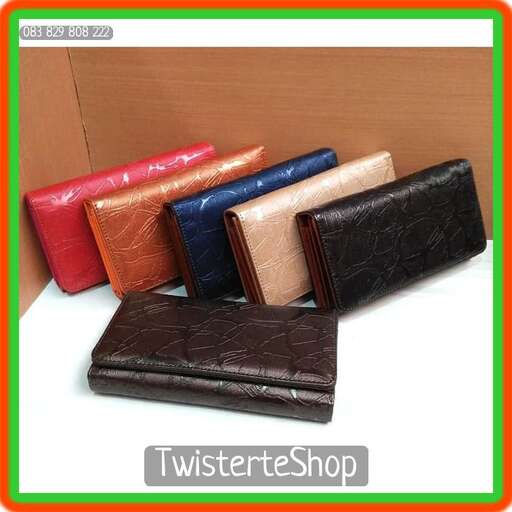 a brown wallet sitting on top of a white surface.