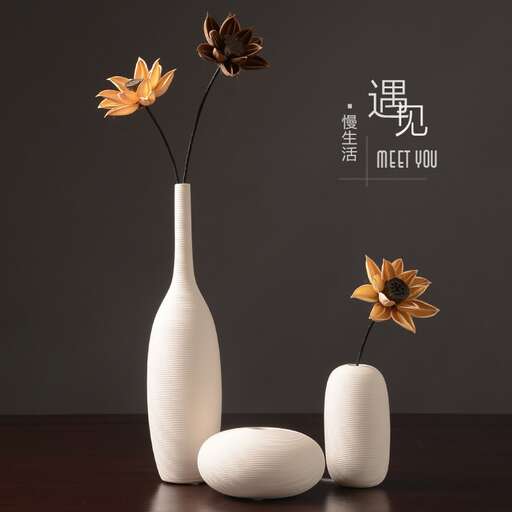 a vase with two flowers in it.