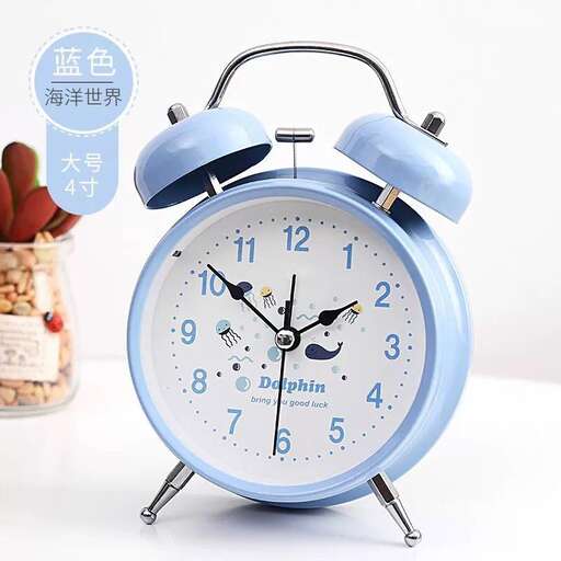 a blue alarm clock with a pot of food in the background.