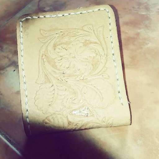 leather wallet with a face on it.