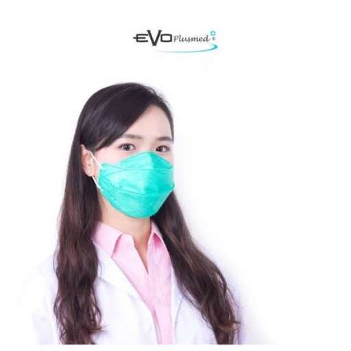 a woman wearing a surgical mask in a white coat