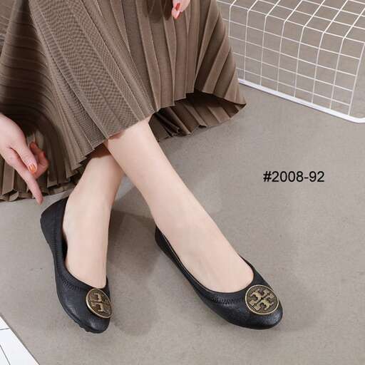 a woman wearing black shoes and a white and black skirt.