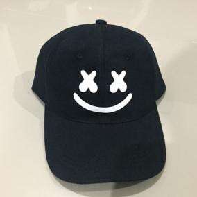 a black baseball cap with a smiley face on it.