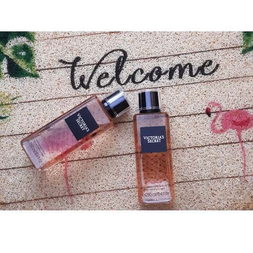 a bottle of perfume with a pink flamingo on top.