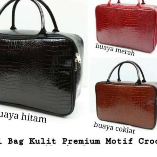 a black leather bag with a red bag on it.