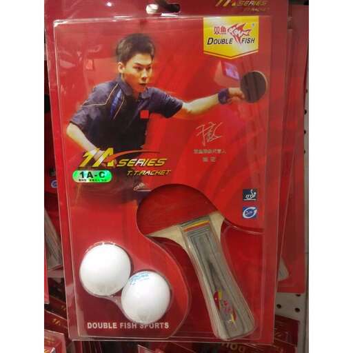 a toy of a boy holding a pair of white tennis balls.