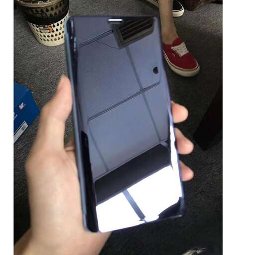 a person holding a cell phone in their hand.