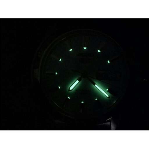 a clock with green lights on it's face.