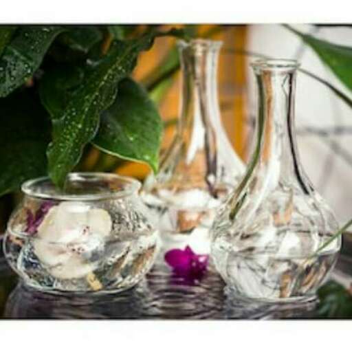 a vase with a flower in it.