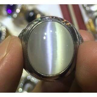 a person holding a silver watch in their hand.
