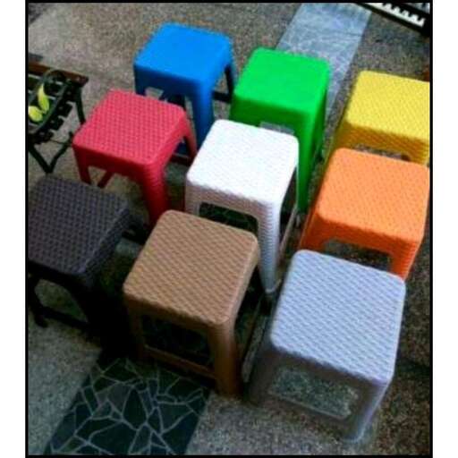 a stack of colorful stools in a room.