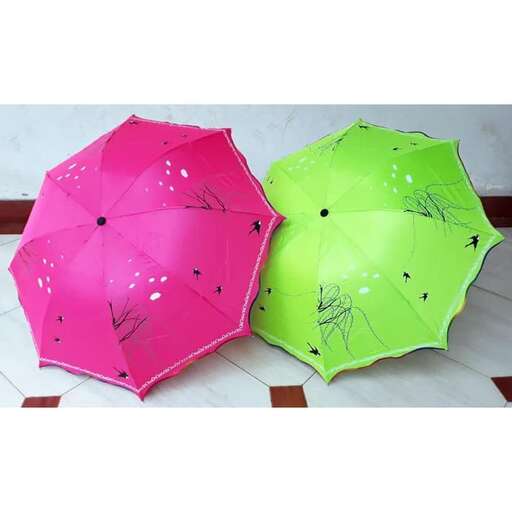 two colorful umbrellas sitting on a tiled floor.